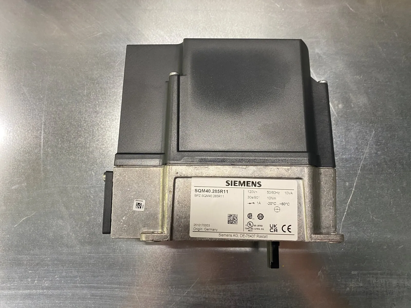 Actionneur de vanne Siemens SQM40, plaque signalétique vers le haut, sur l’établi de l’atelier